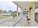Covered porch features comfortable seating and an inviting outdoor living space at 1965 24Th Ave. N, North Myrtle Beach, SC 29582