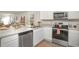 Well-equipped kitchen with stainless steel appliances, bright white cabinetry and a view of the living area at 204 Jeff Waters Circle, Longs, SC 29568