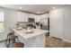 Bright kitchen featuring white cabinets, modern countertops, and stainless steel appliances at 204 Jeff Waters Circle, Longs, SC 29568