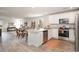 Open-concept kitchen with stainless steel appliances, white cabinets, and a view of the living area at 204 Jeff Waters Circle, Longs, SC 29568