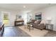 Cozy living room featuring stylish decor, a comfortable sofa, and ample natural light at 204 Jeff Waters Circle, Longs, SC 29568