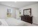 Bright main bedroom with a large window, ample closet space, and stylish furniture at 204 Jeff Waters Circle, Longs, SC 29568