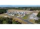 This aerial view shows a new construction community with lush landscaping and paved streets at 207 Calm Dr., Little River, SC 29566
