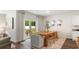 Bright dining room showcasing a wooden table, modern chairs, and sliding glass doors to the backyard at 207 Calm Dr., Little River, SC 29566