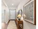 Welcoming hallway with wood flooring, a console table, and contemporary artwork at 207 Calm Dr., Little River, SC 29566