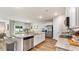 Bright, open kitchen with granite countertops, stainless appliances, and breakfast bar seating at 207 Calm Dr., Little River, SC 29566