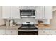 Close-up of kitchen featuring granite counters, stainless steel oven, and white cabinets at 207 Calm Dr., Little River, SC 29566