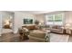 Comfortable living room with stylish furnishings, bright window, and open access to the bedroom at 207 Calm Dr., Little River, SC 29566