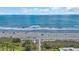 Expansive view of the beach with white sand, blue water, and lush greenery, perfect for relaxation and recreation at 211 76Th Ave. N # A-2, Myrtle Beach, SC 29572