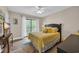 Bright bedroom with a queen bed, ceiling fan, and sliding glass doors to a private balcony at 211 76Th Ave. N # A-2, Myrtle Beach, SC 29572