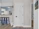 Inviting entryway featuring a glimpse of the kitchen, complemented by stylish bar stools and a beach-themed decor at 211 76Th Ave. N # A-2, Myrtle Beach, SC 29572
