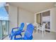 Balcony with blue chairs and white table perfect for enjoying the outdoor view at 2507 S Ocean Blvd. # 802, North Myrtle Beach, SC 29582