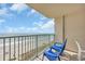 Balcony view of the ocean and beach with blue chairs for relaxing and enjoying the view at 2507 S Ocean Blvd. # 802, North Myrtle Beach, SC 29582