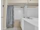 Bright bathroom featuring white vanity sink and combined tub and shower with seashell curtain at 2507 S Ocean Blvd. # 802, North Myrtle Beach, SC 29582
