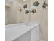 Bathroom with white vanity, sink and large mirror decorated with decorative fish art at 2507 S Ocean Blvd. # 802, North Myrtle Beach, SC 29582