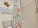 Bright bathroom features a standing shower with a colorful nautical themed curtain at 2507 S Ocean Blvd. # 802, North Myrtle Beach, SC 29582