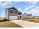 View of the exterior of a two-story home with a two-car garage and long driveway at 2639 Riverboat Way, Conway, SC 29526