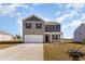 Two-story home with neutral siding, grey trim, a two-car garage, and manicured front yard at 2639 Riverboat Way, Conway, SC 29526