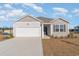 Charming single-story home featuring a two-car garage, manicured lawn, and neutral-toned siding at 2820 Riverboat Way, Conway, SC 29526