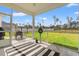 Inviting screened-in porch with ceiling fan, dining area, and a lush green backyard at 2827 Allen Dew Rd., Conway, SC 29527