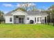 Sprawling backyard featuring a well-kept lawn, screened-in porch, dining area, and black fencing at 2827 Allen Dew Rd., Conway, SC 29527