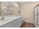 Bathroom with dual sink vanity, shower, and wood look flooring at 2827 Allen Dew Rd., Conway, SC 29527
