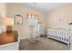 Cozy Bedroom with white crib, rocking chair, and large window with decorative valance at 2827 Allen Dew Rd., Conway, SC 29527