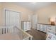 Bedroom showcases a crib, dressers, closet, and neutral carpeting at 2827 Allen Dew Rd., Conway, SC 29527