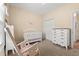 Charming Bedroom featuring a white crib, rocking chair, and lovely butterfly artwork at 2827 Allen Dew Rd., Conway, SC 29527
