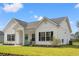Charming home with a teal front door, black shutters, rocking chairs, and green lawn at 2827 Allen Dew Rd., Conway, SC 29527
