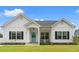 Charming single-story home features a bright blue front door and a well-manicured lawn at 2827 Allen Dew Rd., Conway, SC 29527
