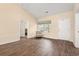 Bright living room showcasing wood floors, neutral paint, and natural light through the window at 2827 Allen Dew Rd., Conway, SC 29527