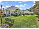 Expansive backyard featuring lush lawn, mature landscaping, and patio area with outdoor seating at 3148 Bayhaven Dr., Myrtle Beach, SC 29579