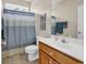 Well-lit bathroom features a vanity with a white countertop and a blue shower curtain at 3148 Bayhaven Dr., Myrtle Beach, SC 29579