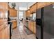 Kitchen boasts ample wood cabinetry, a tile floor, and modern black appliances at 3148 Bayhaven Dr., Myrtle Beach, SC 29579