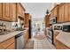 Bright kitchen includes stainless steel appliances, tile floor, and wooden cabinets, with views of the dining room at 3148 Bayhaven Dr., Myrtle Beach, SC 29579
