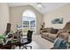 Bright office space featuring a large arched window, modern desk, and comfortable seating area at 3148 Bayhaven Dr., Myrtle Beach, SC 29579