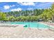 Large outdoor pool with lounge chairs and clear blue water, surrounded by lush trees at 3148 Bayhaven Dr., Myrtle Beach, SC 29579