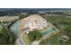 An aerial view showcases a community with lake views and lush greenery at 315 Glade Ct., Loris, SC 29569