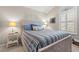 Bright bedroom with natural light, a cozy striped bedspread, and charming coastal decor accents at 323 14Th Ave. S # B, Surfside Beach, SC 29575