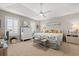 Inviting bedroom features a ceiling fan, shuttered windows and a bed with seashell patterned comforter at 323 14Th Ave. S # B, Surfside Beach, SC 29575