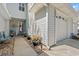 Home's front entry showing blue chairs, potted plants, and a one-car garage at 323 14Th Ave. S # B, Surfside Beach, SC 29575