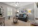 Living room with a ceiling fan, large window with shutters, and neutral paint at 323 14Th Ave. S # B, Surfside Beach, SC 29575