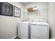 Efficient laundry room with a front-load washer and dryer, storage shelves, and a clean, organized layout at 319 Myrtle Meadows Dr # 401D, Conway, SC 29526