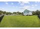 Expansive backyard with lush green grass, white picket fence, and rear home exterior at 3851 Journeys End Rd., Murrells Inlet, SC 29576