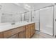 Bathroom featuring double sinks, wood cabinets, large vanity mirror, and a glass enclosed shower at 3851 Journeys End Rd., Murrells Inlet, SC 29576