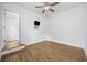 Bedroom with hardwood floors and ceiling fan featuring doors leading to closet and adjoining room at 3851 Journeys End Rd., Murrells Inlet, SC 29576