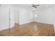 Bedroom with hardwood floors and ceiling fan featuring doors leading to an ensuite bathroom and a closet at 3851 Journeys End Rd., Murrells Inlet, SC 29576