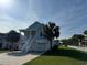 Charming two-story coastal home with a white picket fence and lush green lawn at 3851 Journeys End Rd., Murrells Inlet, SC 29576