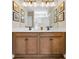 This bathroom features and sinks, wooden cabinets, and framed botanical decor at 393 Sun Colony Blvd., Longs, SC 29568